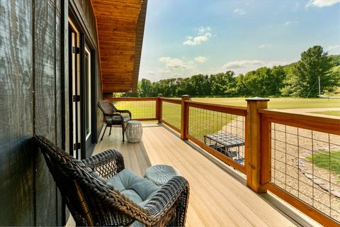 Wicker chairs on the deck overlooking the fields and treeline