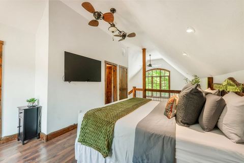 King master bedroom with tasteful cabin decor and warm wood accents