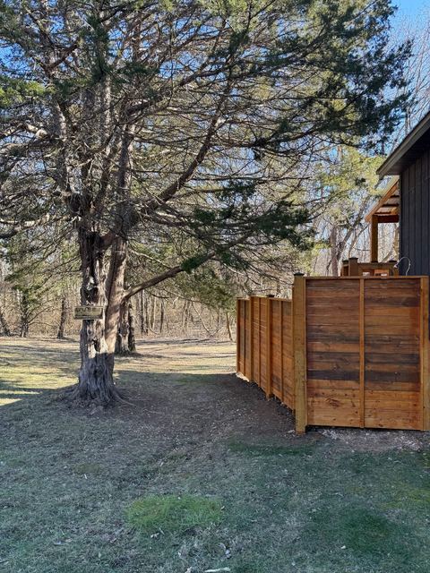 The freestanding cedar outdoor shower in its woodland setting
