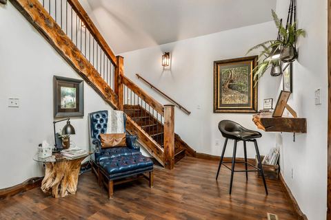 Entry landing and staircase with a tufted bench and timber railing